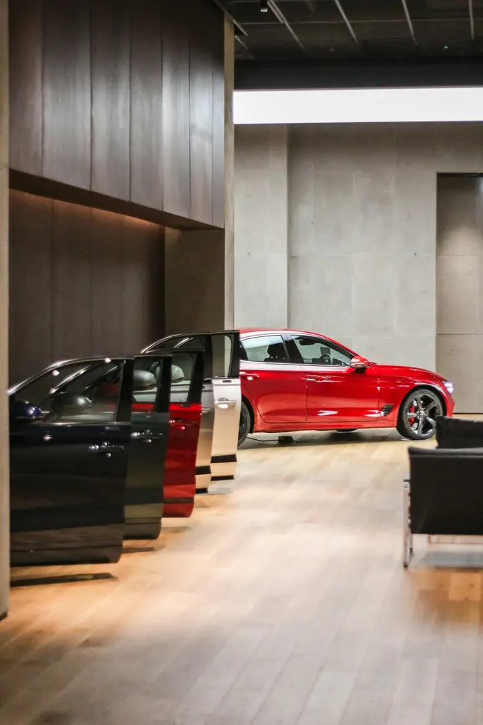A red car inside a bright showroom