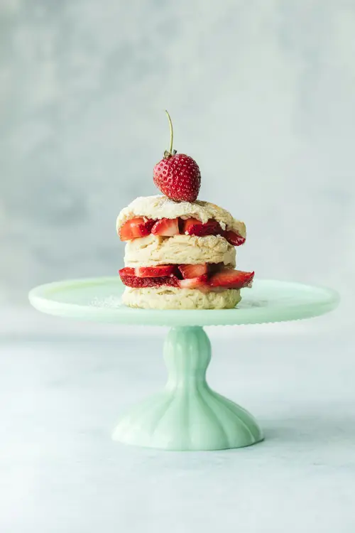 A strawberry cake on a mint cake stand