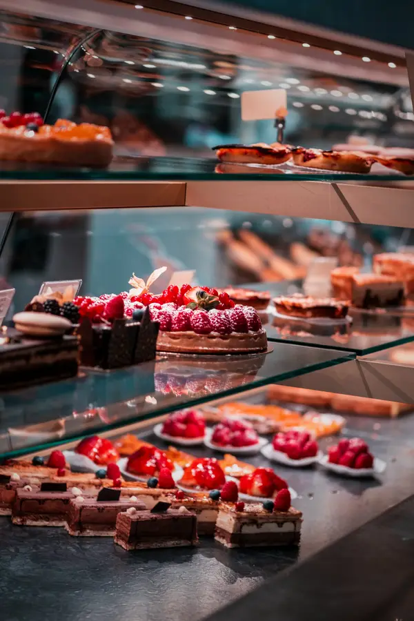 A pastry counter with fruit tarts